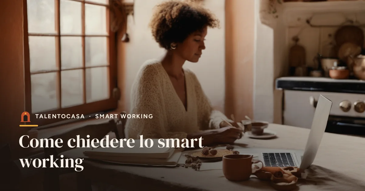 Persona che scrive un'email al portatile al tavolo di cucina